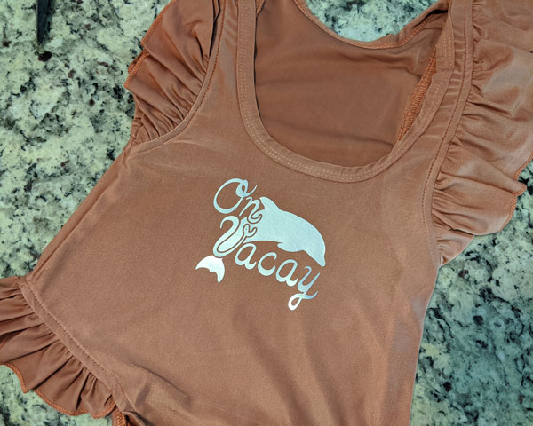 ThermoFlex Turbo Brights pressed onto a frilly swimsuit that says "On Vacay"