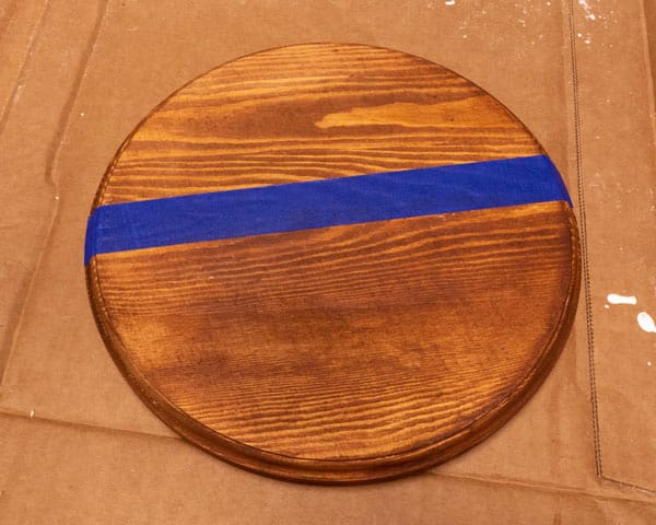 The stained door round has been taped off using blue painter's tape