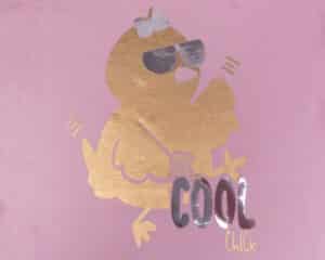 A shirt with a chick in sunglasses and a bow that reads "one cool chick" in Super Gold and Brilliant Silver DecoFilm