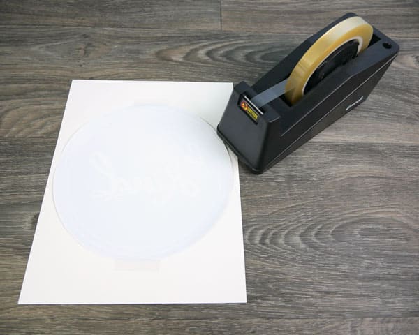 The GlitterFlex Ultra being lined up on a piece of sublimation paper with some ThermoTape